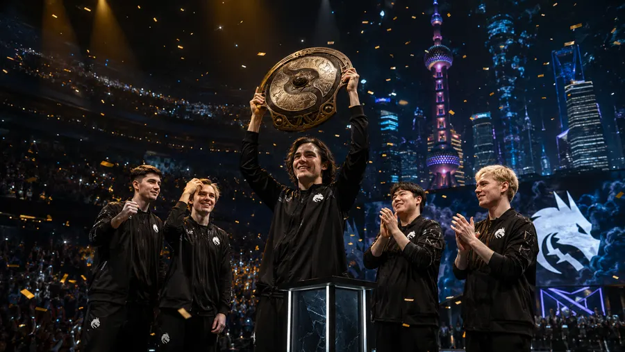Pemain Team Spirit merayakan kemenangan di atas panggung bersama trofi Aegis of Champions, dengan latar kota Shanghai